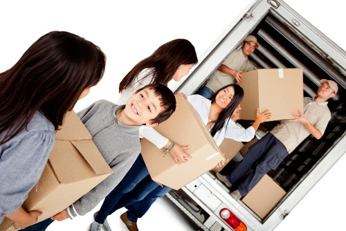 Removal team planning a flat move with boxes and furniture in Queenspark