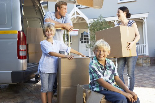 Loading boxes and furniture into a removals vehicle for a Queenspark flat move